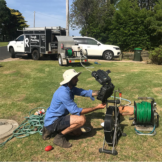 Jindabyne Plumber investigating and fixing a blocked drain issue at a home